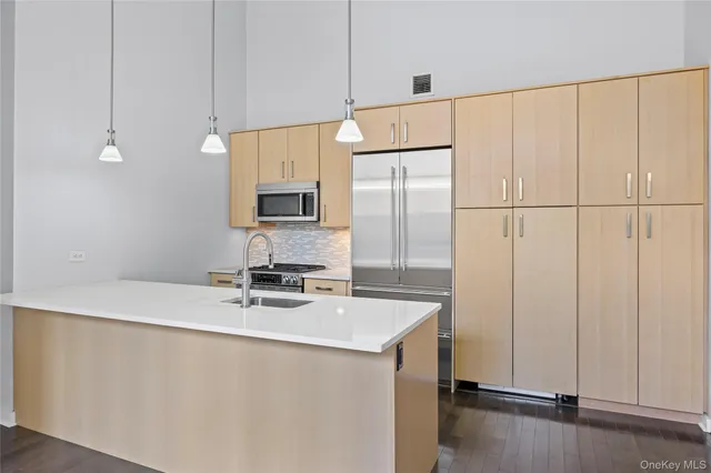 a kitchen with a sink a stove and a refrigerator