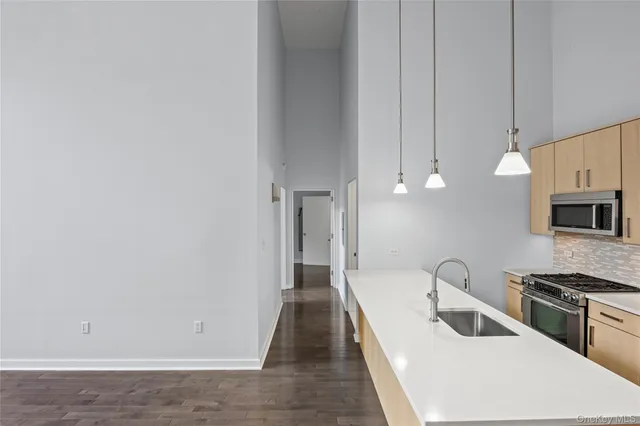 a kitchen with a sink and a refrigerator