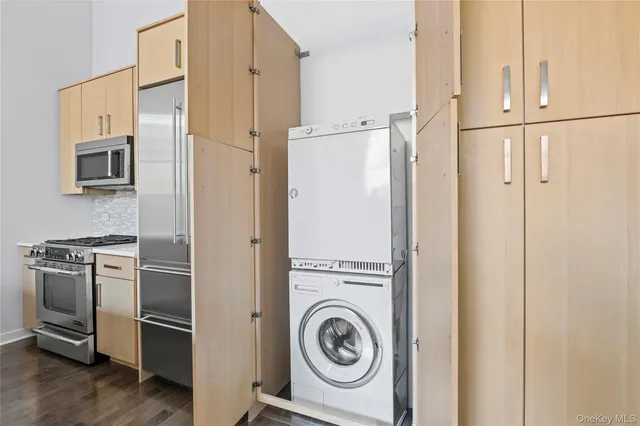 a view of kitchen with stainless steel appliances refrigerator and microwave
