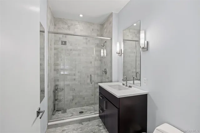 a bathroom with a shower sink and mirror