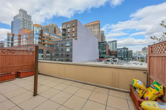 a swimming pool with outdoor seating and city view