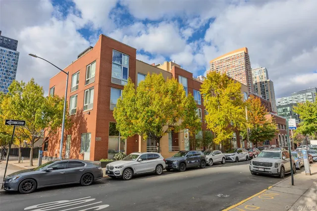 a couple of cars parked in front of a building