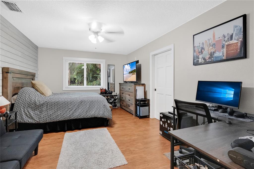 4410 Mildred Bass Road St. Cloud, FL 34772 - Photo 13 of 42 a living room with furniture and a flat screen tv