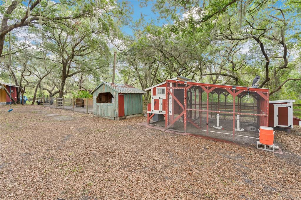 4410 Mildred Bass Road St. Cloud, FL 34772 - Photo 22 of 42 a view of a house with a yard and garage