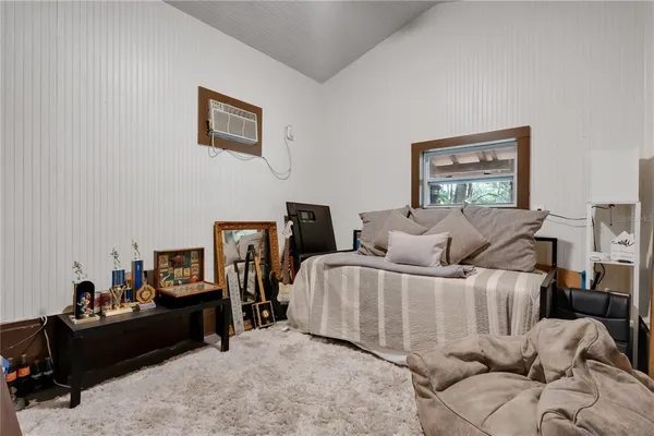 a bed room with bed and a window