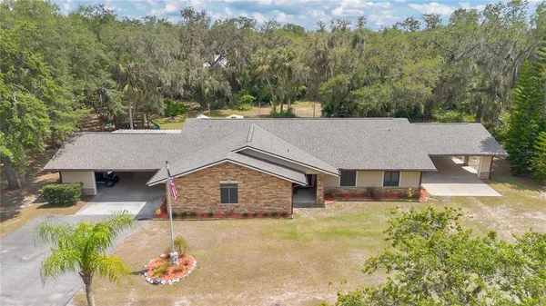 an aerial view of a house with a yard