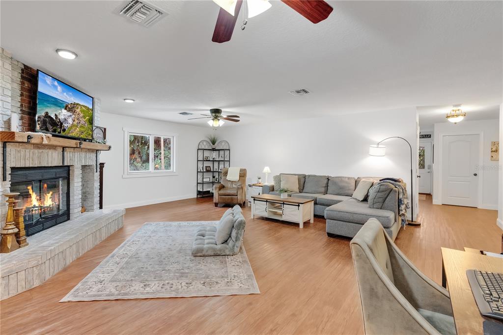 4410 Mildred Bass Road St. Cloud, FL 34772 - Photo 4 of 42 a living room with furniture or couch and a fireplace