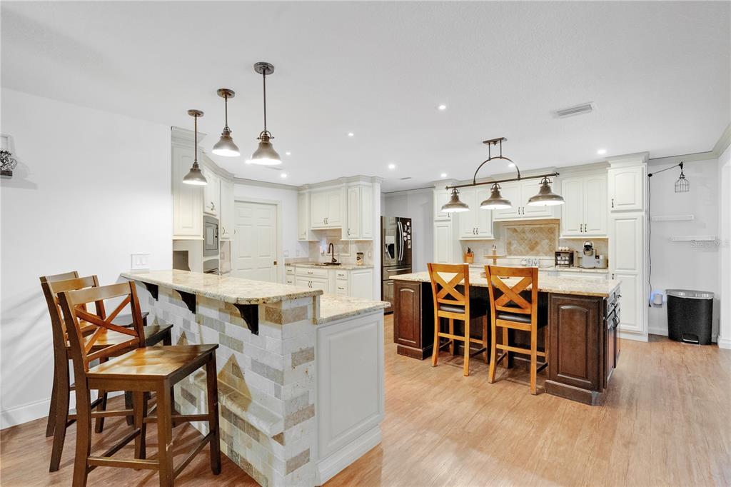 4410 Mildred Bass Road St. Cloud, FL 34772 - Photo 10 of 42 a view of a dining room with furniture and wooden floor
