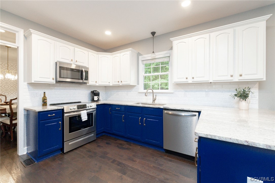 15725 Fox Marsh Drive Moseley, VA 23120 - Photo 14 of 50 a kitchen with stainless steel appliances granite countertop wooden cabinets a stove a sink and a window