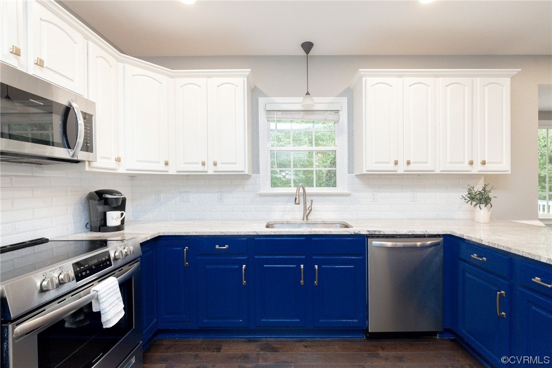 15725 Fox Marsh Drive Moseley, VA 23120 - Photo 15 of 50 a kitchen with stainless steel appliances granite countertop a sink a stove and a microwave