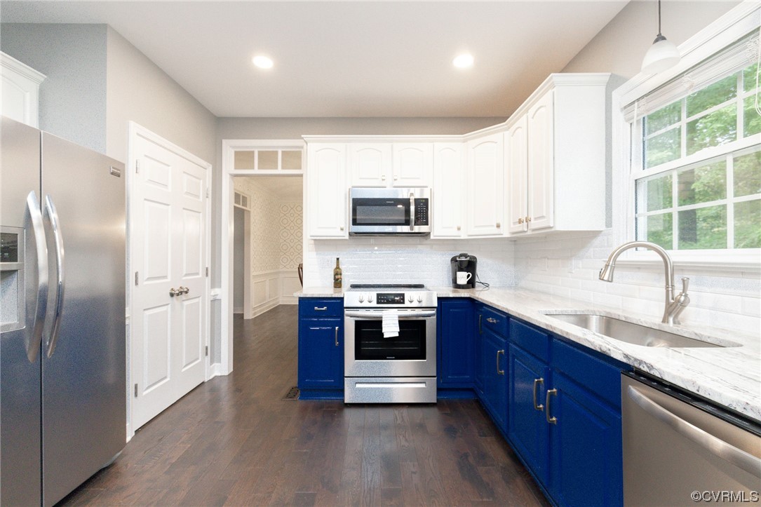 15725 Fox Marsh Drive Moseley, VA 23120 - Photo 16 of 50 a kitchen with stainless steel appliances granite countertop a refrigerator a sink a stove a microwave and wooden cabinets