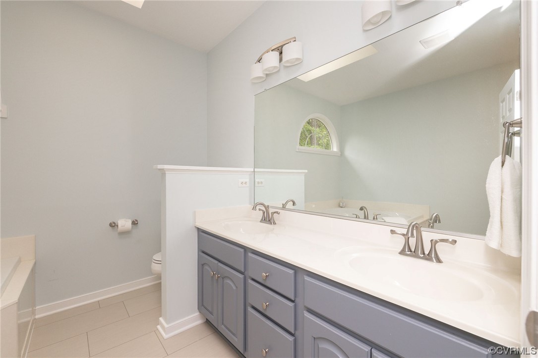 15725 Fox Marsh Drive Moseley, VA 23120 - Photo 34 of 50 a bathroom with a sink and a mirror