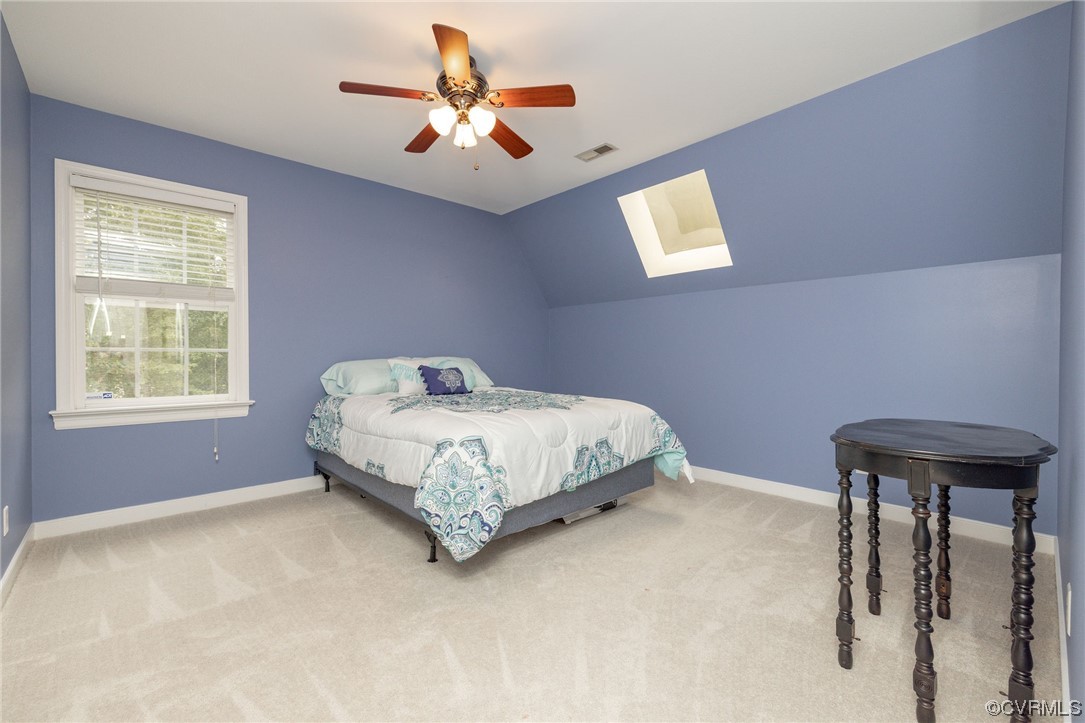 15725 Fox Marsh Drive Moseley, VA 23120 - Photo 41 of 50 a bedroom with a bed and a chandelier