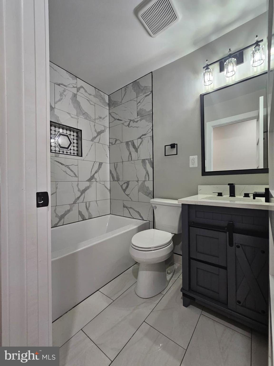 2909 Chapelview Drive Silver Spring, MD 20904 - Photo 16 of 39 a bathroom with a toilet a sink a mirror a bathtub and vanity