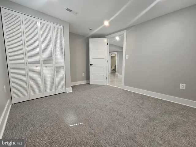 an empty room with closet area