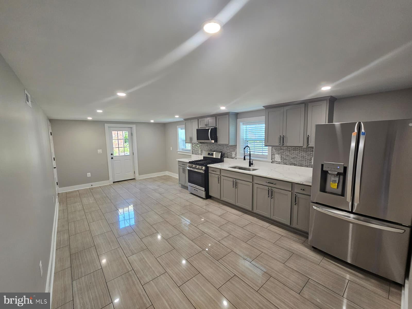 2909 Chapelview Drive Silver Spring, MD 20904 - Photo 26 of 39 a kitchen with stainless steel appliances granite countertop a refrigerator sink and cabinets