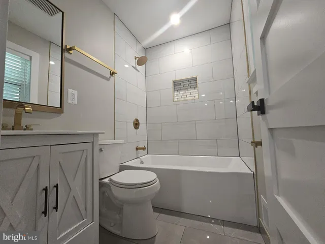 a bathroom with a sink a toilet and a bathtub