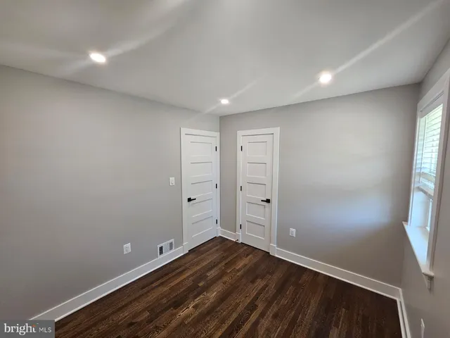 wooden floor in an empty room with windows