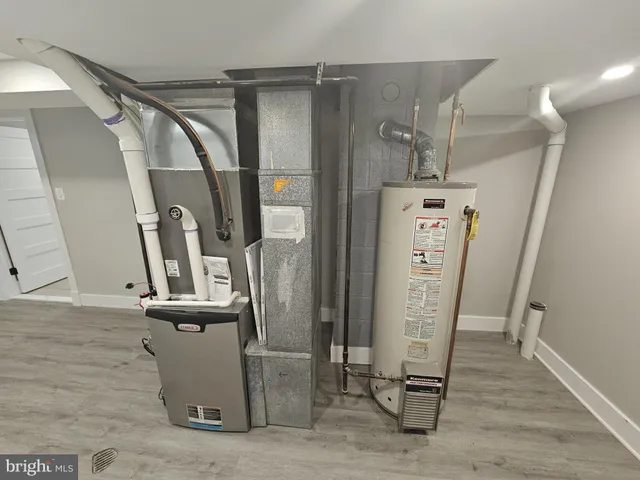 a view of a storage & utility room with refrigerator