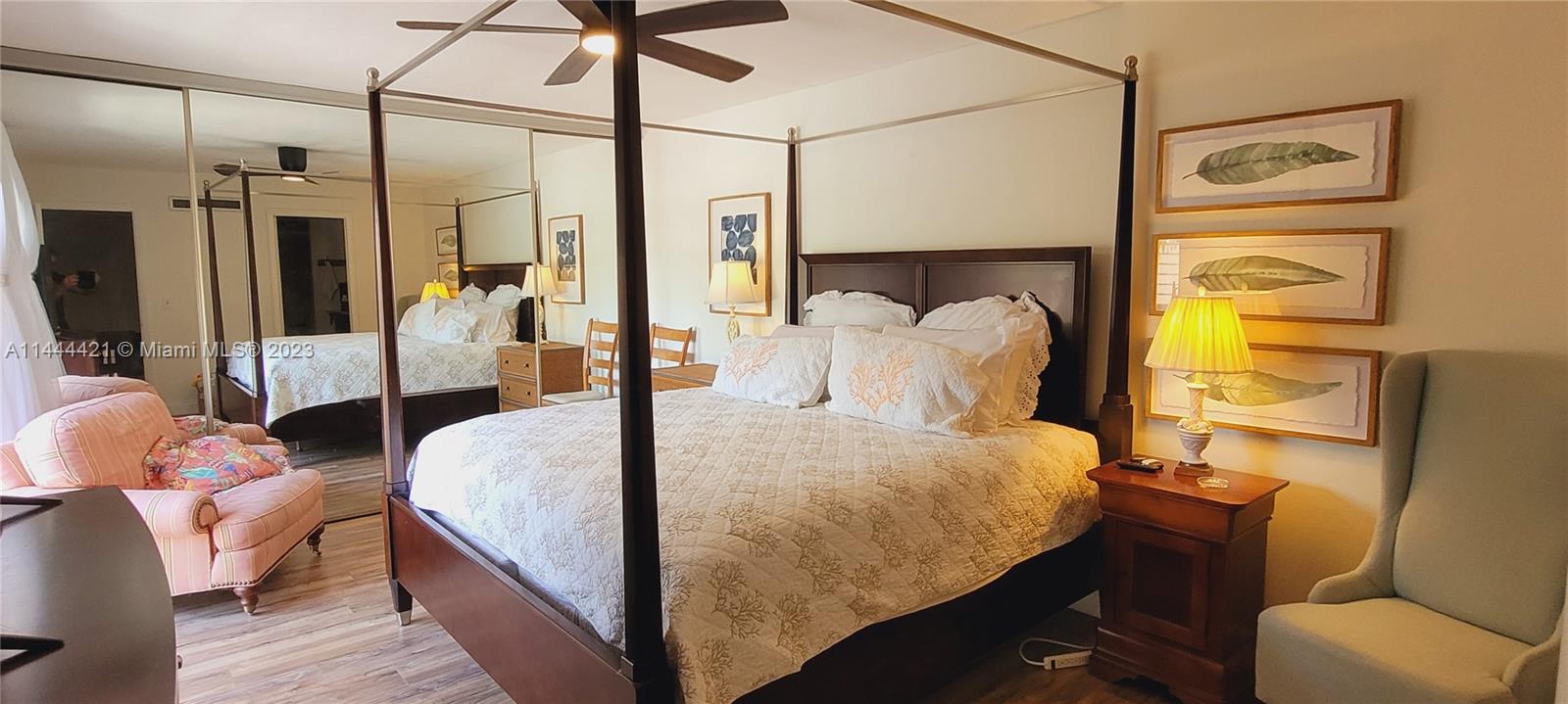 825 Center Street, Unit 28C Jupiter, FL 33458 - Photo 11 of 29 a bedroom with a bed and wooden floor