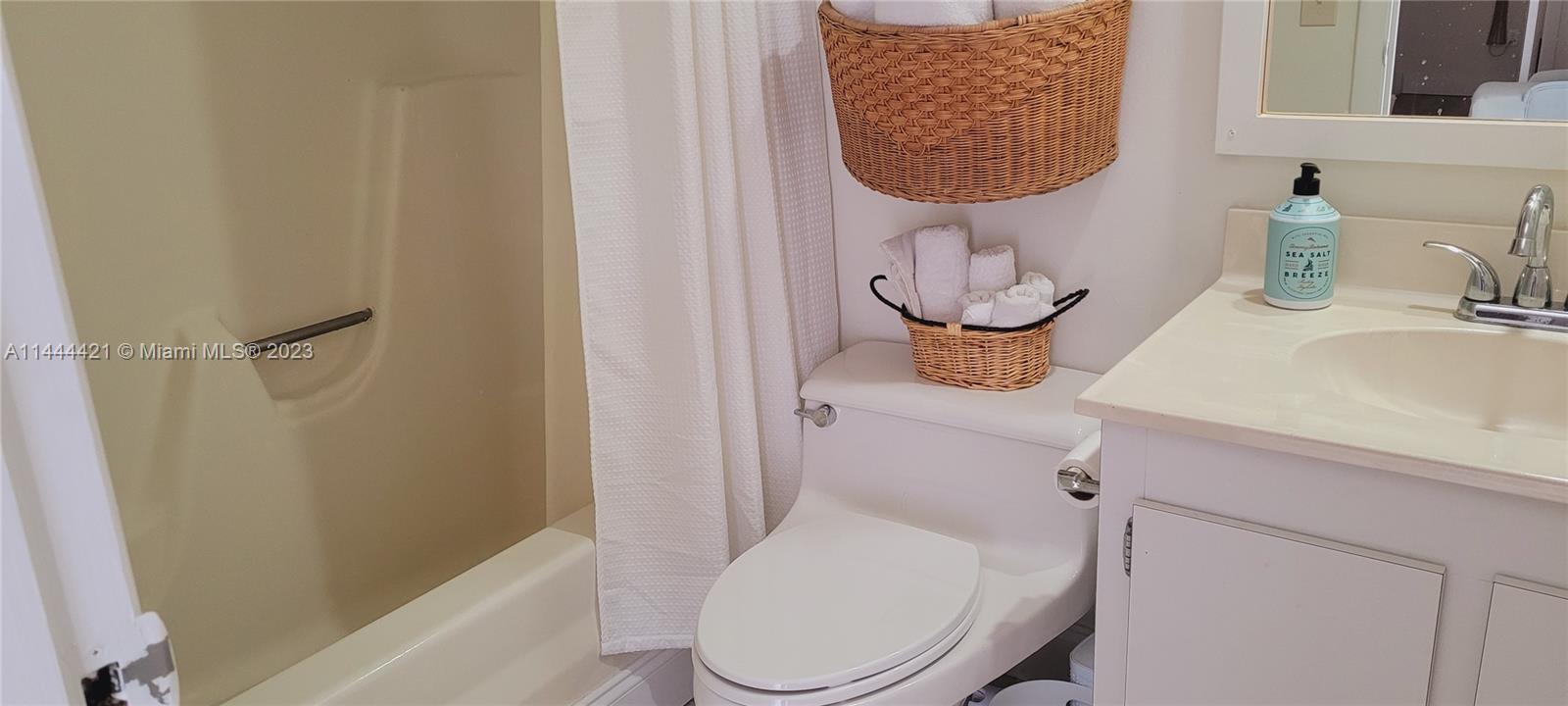 825 Center Street, Unit 28C Jupiter, FL 33458 - Photo 14 of 29 a bathroom with a toilet sink and mirror