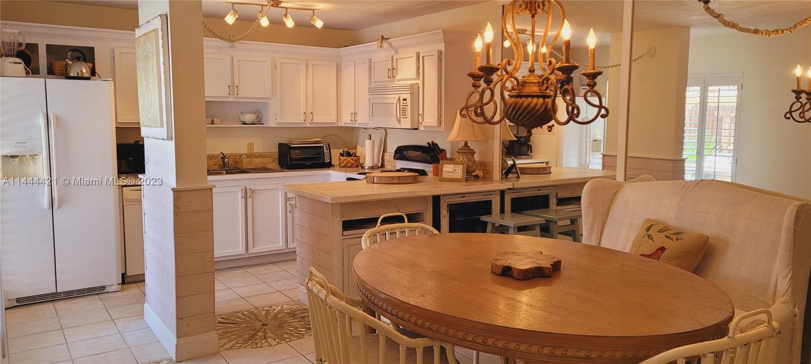 825 Center Street, Unit 28C Jupiter, FL 33458 - Photo 6 of 29 a kitchen with stainless steel appliances granite countertop a sink a refrigerator and a stove