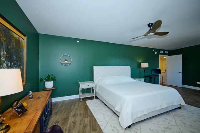 a bedroom with a bed and a chandelier