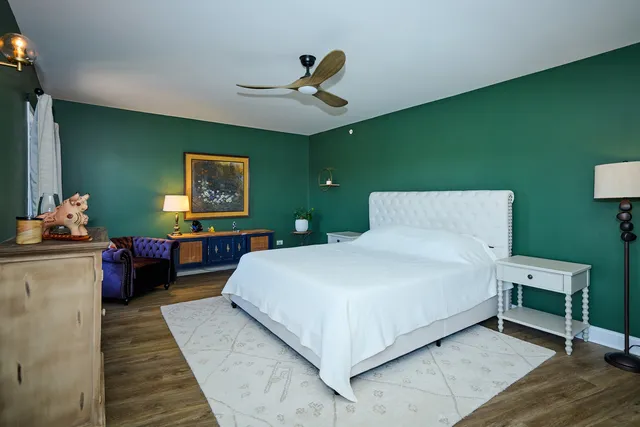 a bed room with a bed and a chandelier