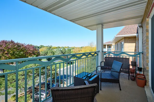 a view of a chair and tables in the balcony