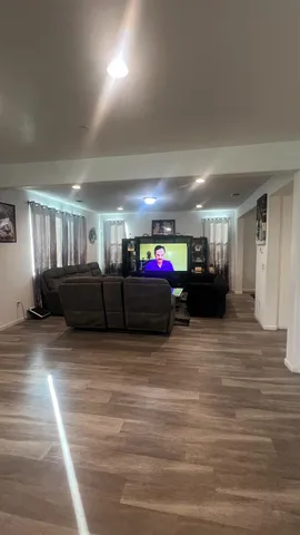 a living room with lots of furniture and a wooden floor