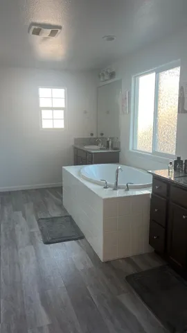 a view of a room with wooden floor and window
