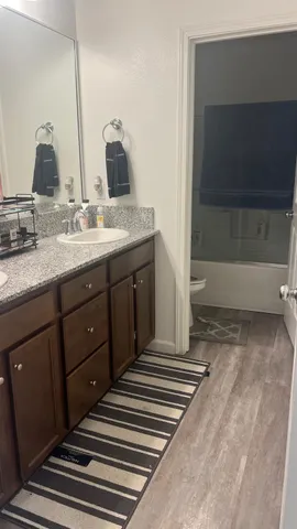 a bathroom with a double vanity sink and a mirror