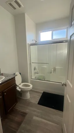 a bathroom with a toilet a sink and shower