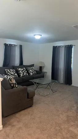 a living room with furniture and a lamp