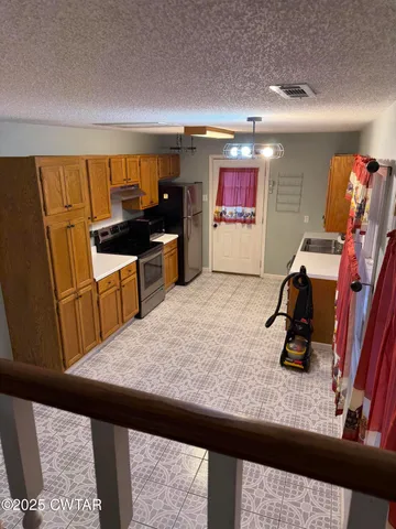 a kitchen with stainless steel appliances granite countertop a sink wooden cabinets and a counter top space