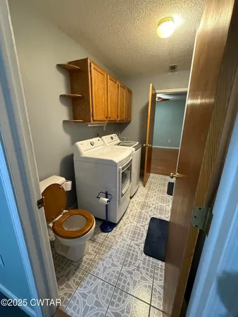 a view of bathroom with toilet sink and mirror