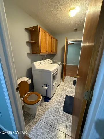 a view of bathroom with toilet sink and mirror