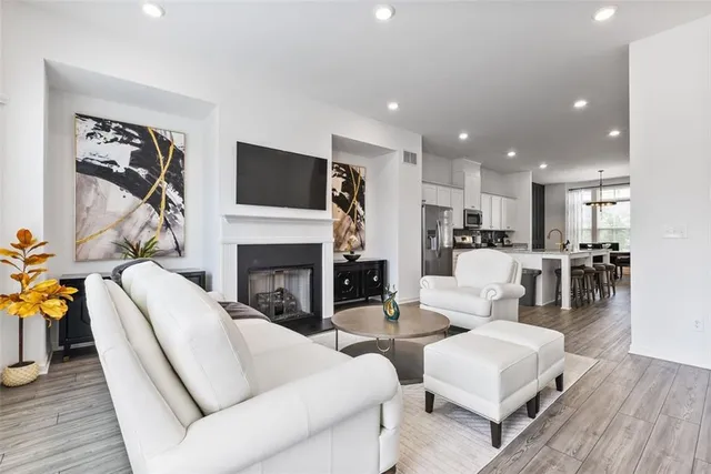 a living room with furniture fireplace and a large window
