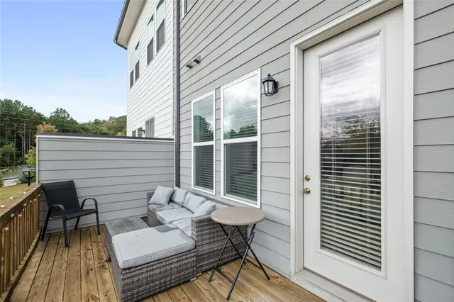 a view of a balcony with couches and wooden floor