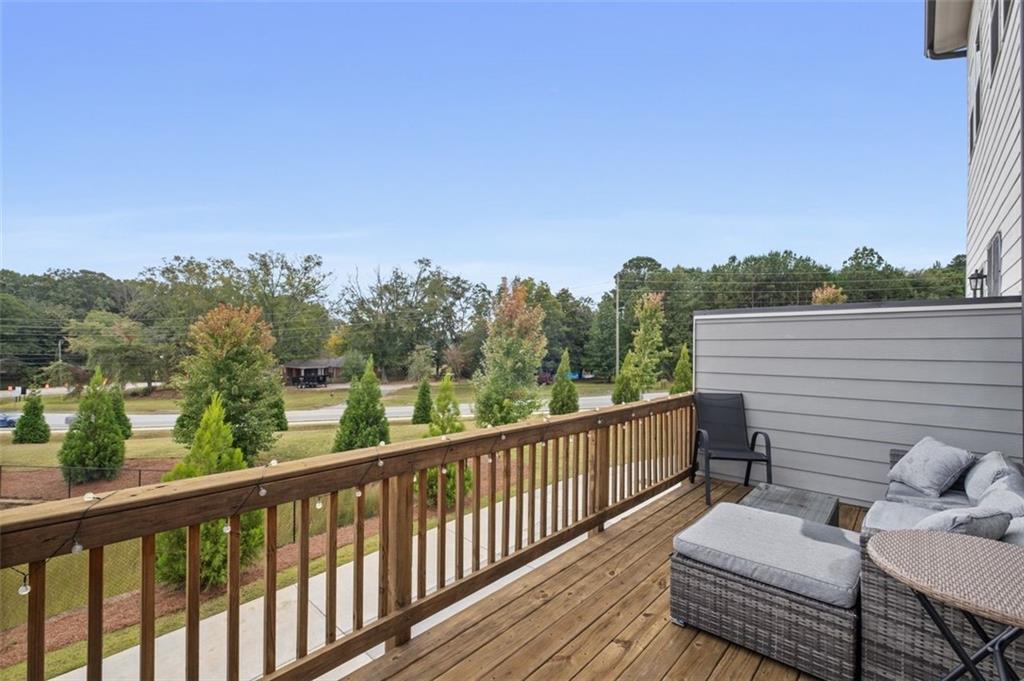 1182 Edwin Lane Sugar Hill, GA 30518 - Photo 15 of 32 a view of a balcony with couches and wooden floor