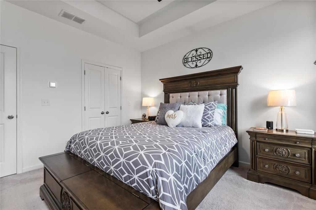 1182 Edwin Lane Sugar Hill, GA 30518 - Photo 18 of 32 a bedroom with a bed and a lamp