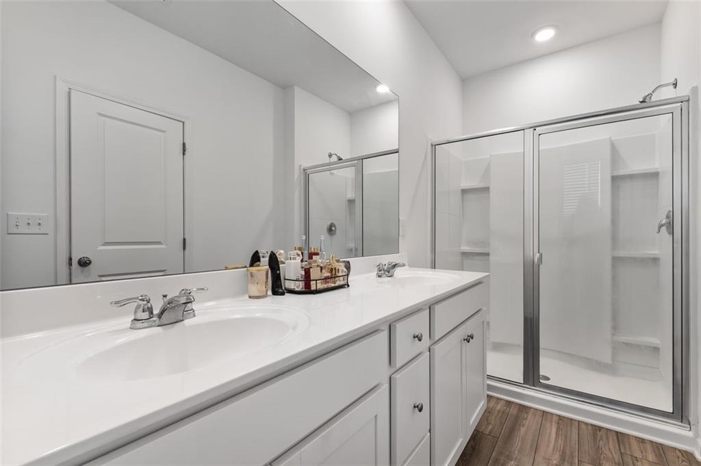 1182 Edwin Lane Sugar Hill, GA 30518 - Photo 19 of 32 a bathroom with double sink and a mirror