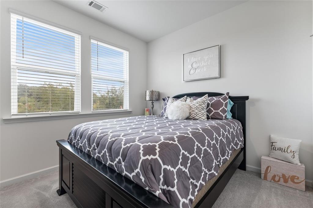 1182 Edwin Lane Sugar Hill, GA 30518 - Photo 20 of 32 a bedroom with a bed and window