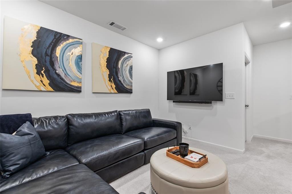 1182 Edwin Lane Sugar Hill, GA 30518 - Photo 29 of 32 a living room with furniture and a flat screen tv