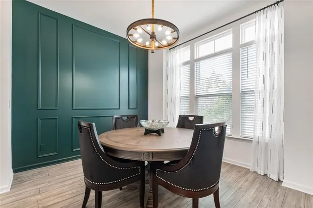 a kitchen with stainless steel appliances granite countertop a stove a sink dishwasher a microwave oven with cabinets and wooden floor