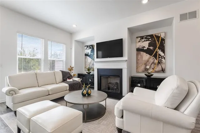 a living room with furniture fireplace and flat screen tv