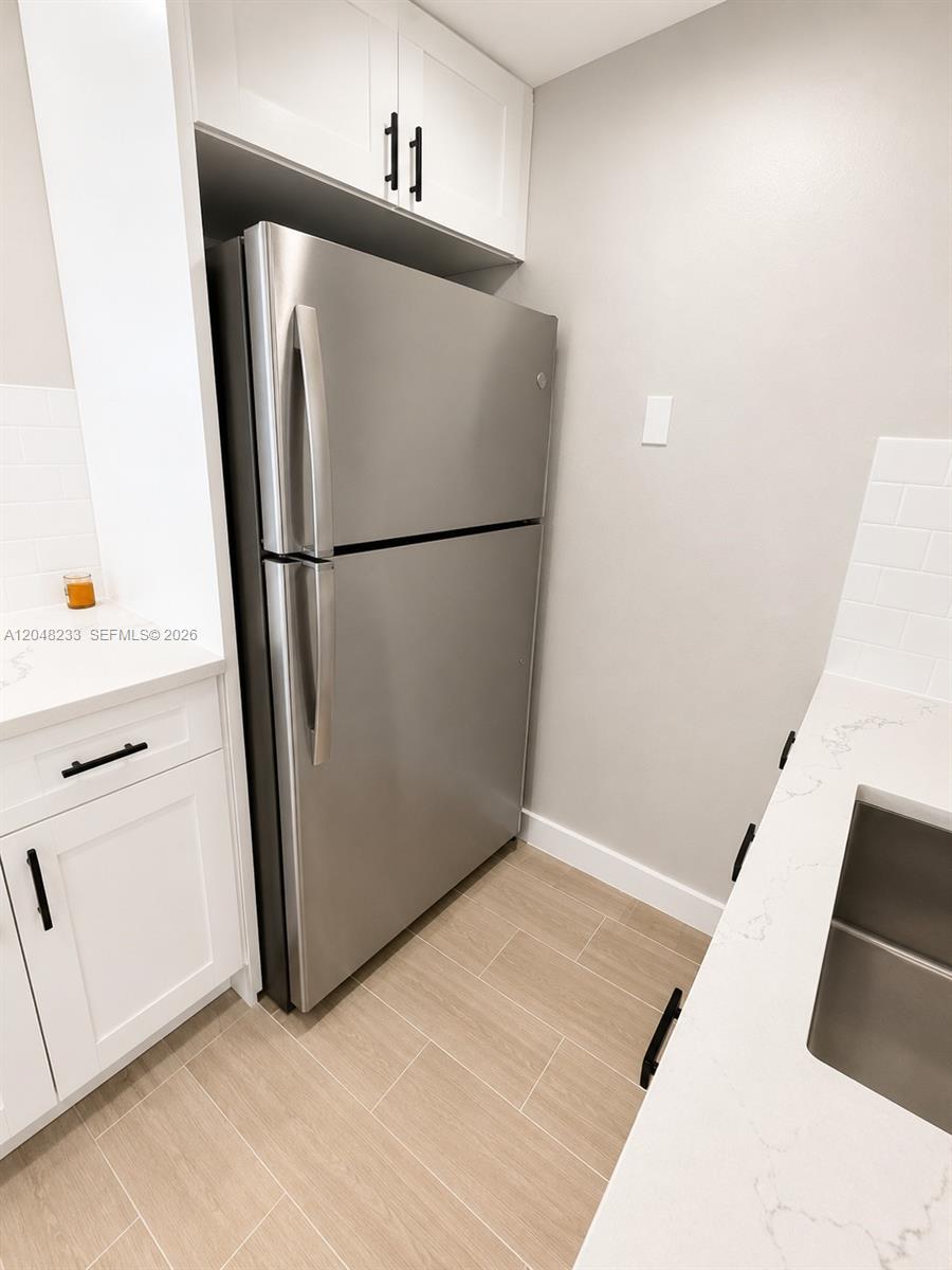 1530 Southwest 2nd Street, Unit 307 Miami, FL 33135 - Photo 3 of 7 a white refrigerator freezer sitting in a kitchen