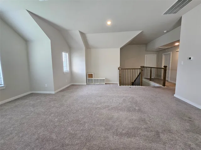 an empty room with a fireplace and painted walls