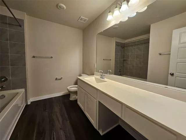 a bathroom with a sink a toilet a shower and a mirror