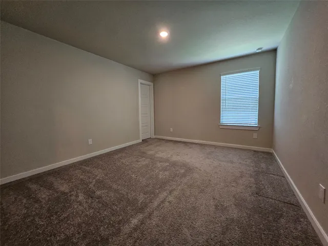 an empty room with a empty space and windows